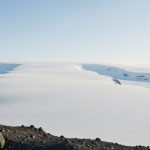 Arktische Landschaft mit felsigem Terrain und Eisfeldern – Symbol für Grönlands Rohstoffpotenzial