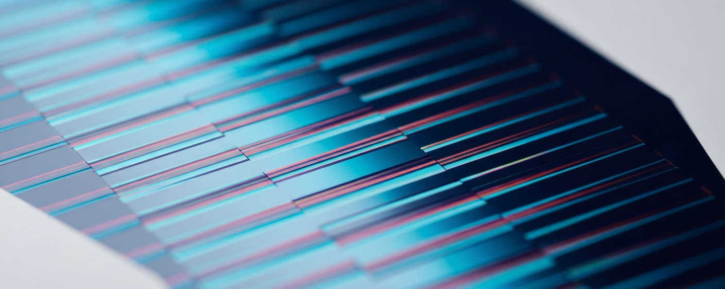 Semiconductor wafer with cyan-magenta interference patterns on a white cleanroom background