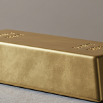 Goldbarren auf grauer Steinoberfläche – Symbol für Kapitalfluss im Goldsektor