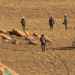 Geophysik-Team mit Elektroden-Equipment auf Kupfer-Explorationsprojekt in der Steppe